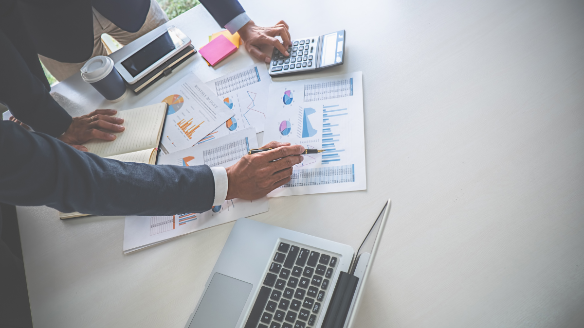 Team collaborating around screens